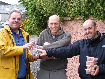 Iain McWhinney presenting RAFTS Challenge Trophy to James Hunt and Kenny Gault