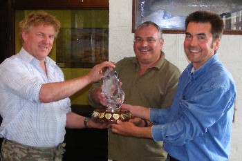Carl Forbes & Nick Benge recieving the trophy from Loch Maree Hotel Ghillie, Fred Robertson.